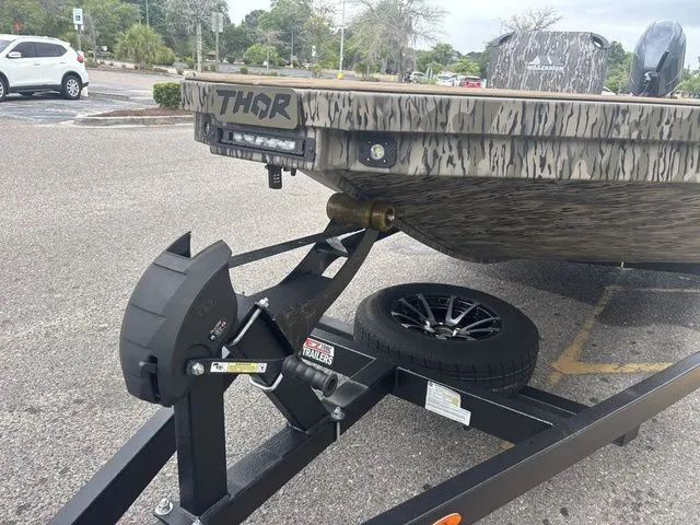 Slide: The Image of Thor Boats 1860 Lake Hammer Elite 2026 parked on trailer outdoors. - 9