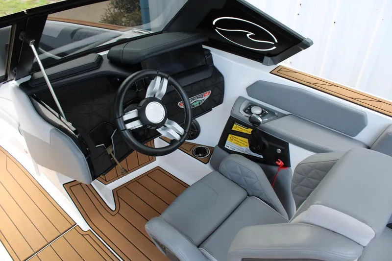 Slide: The Image of 2023 Nautique Super Air Nautique GS20 boat interior with sleek steering and modern controls. - 14