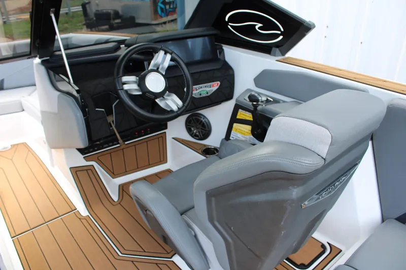 Slide: The Image of 2023 Nautique Super Air Nautique GS20 boat interior with modern steering and seating. - 15