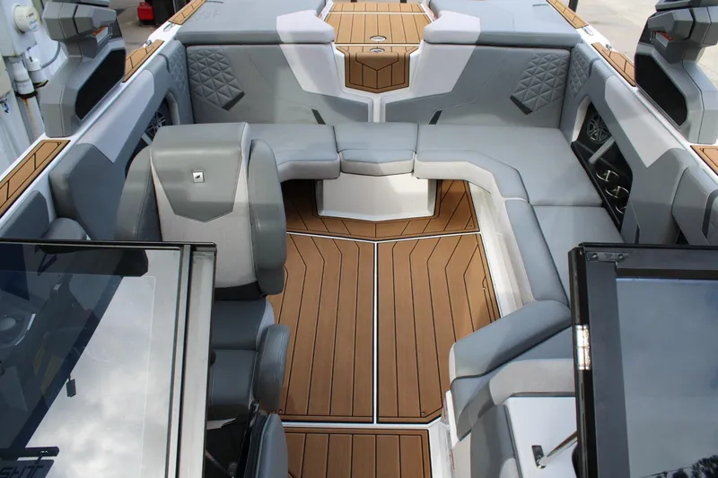 Slide: The Image of 2023 Nautique Super Air Nautique GS20 interior with luxurious seating and teak flooring. - 19