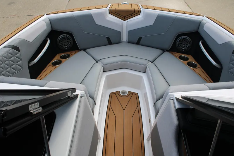 Slide: The Image of 2023 Nautique Super Air Nautique GS20 boat interior with luxurious seating and cup holders. - 22