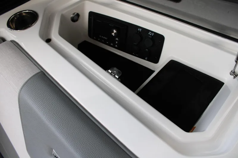 Slide: The Image of 2023 Nautique Super Air Nautique GS20 interior console with control panel and cup holder. - 23