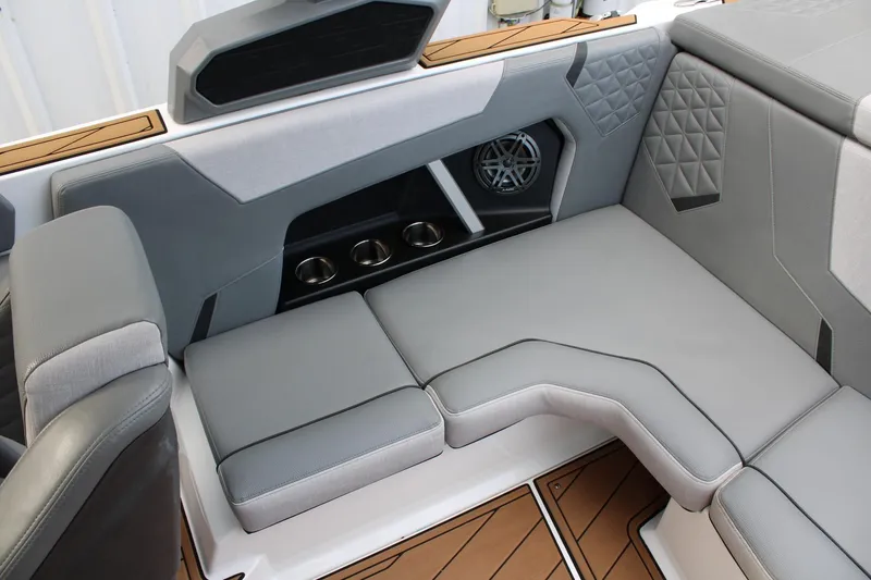 Slide: The Image of 2023 Nautique Super Air Nautique GS20 interior with gray seating and cup holders. - 24