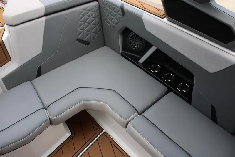 Slide: The Image of 2023 Nautique Super Air Nautique GS20 interior with gray seating and cup holders. - 25