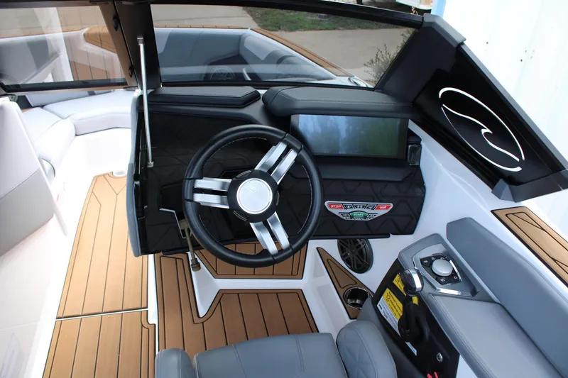Slide: The Image of 2023 Nautique Super Air Nautique GS20 cockpit with modern steering and control panel. - 26