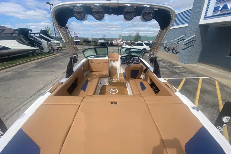 Slide: The Image of 2023 MasterCraft NXT21 boat interior with tan seating and modern dashboard. - 10