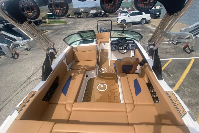 Slide: The Image of 2023 MasterCraft NXT21 boat interior with tan seating and modern dashboard design. - 11
