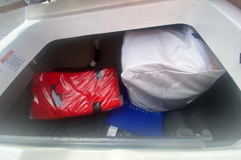 Slide: The Image of Storage compartment of 2023 MasterCraft NXT21 boat with life jackets and gear. - 14