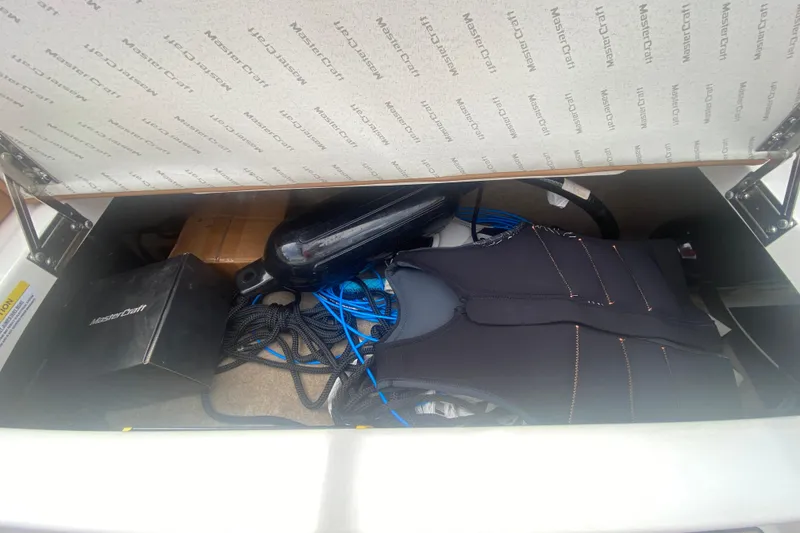 Slide: The Image of Storage compartment of 2023 MasterCraft NXT21 boat with equipment and accessories. - 19