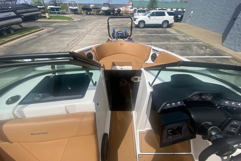 Slide: The Image of 2023 MasterCraft NXT21 boat interior with tan seating and modern dashboard design. - 22