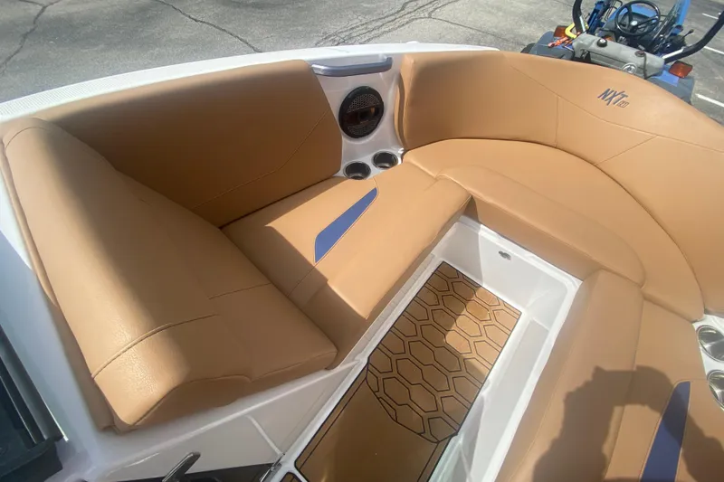 Slide: The Image of 2023 MasterCraft NXT21 boat interior with tan seating and hexagonal floor design. - 25