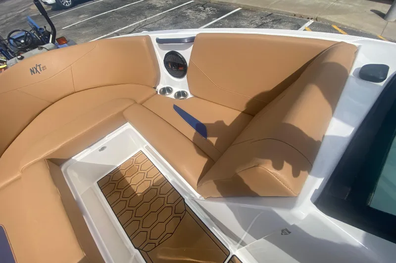 Slide: The Image of 2023 MasterCraft NXT21 boat interior with tan seating and stylish flooring. - 26