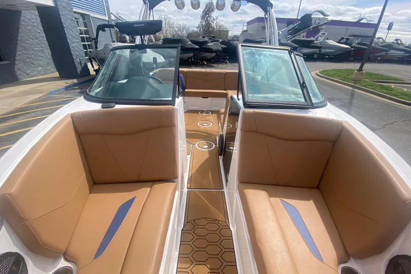 Slide: The Image of 2023 MasterCraft NXT21 boat interior with tan seating and modern design. - 27