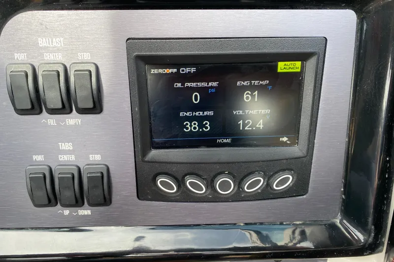 Slide: The Image of Control panel of 2023 MasterCraft NXT21 boat displaying engine metrics and ballast switches. - 28