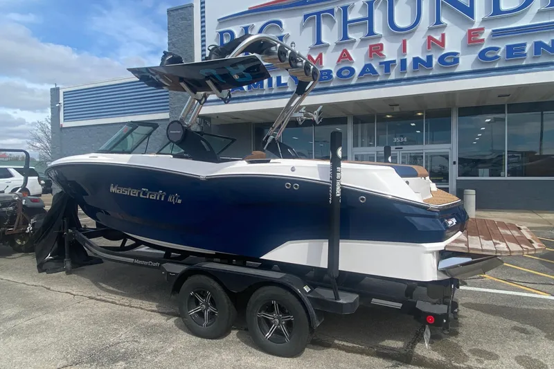 Slide: The Image of 2023 MasterCraft NXT21 boat on trailer at Big Thunder Marine center. - 3