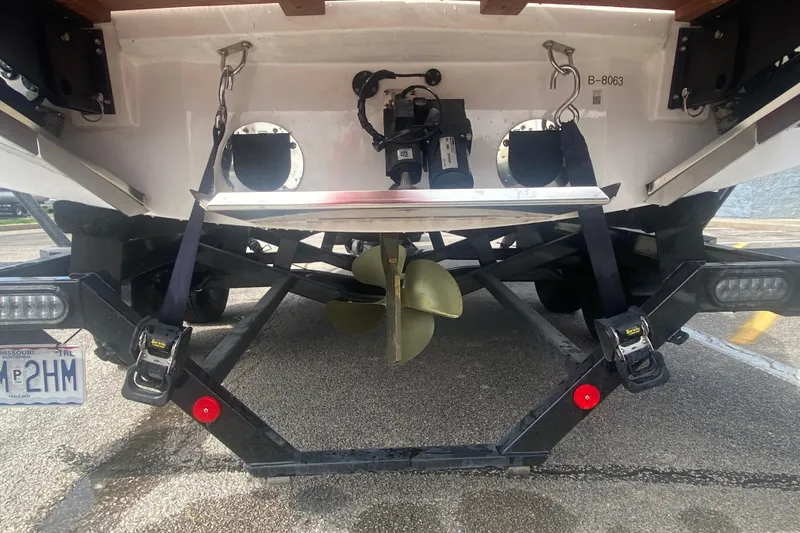 Slide: The Image of 2023 MasterCraft NXT21 boat stern view with propeller and trailer details. - 5