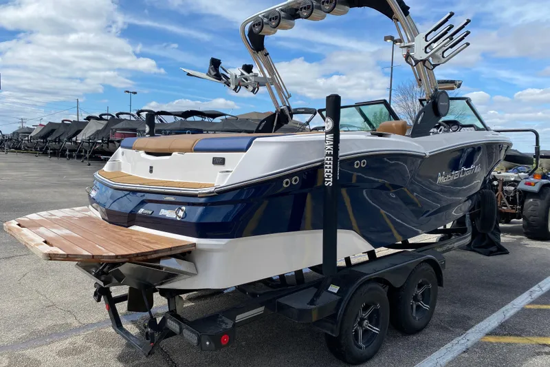Slide: The Image of 2023 MasterCraft NXT21 boat on trailer, featuring sleek design and wakeboard tower. - 6