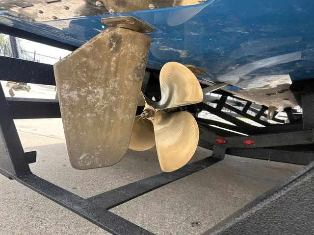 Slide: The Image of 2018 Supra SL boat with propeller and rudder on trailer. - 12
