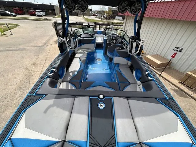Slide: The Image of Interior of a 2018 Supra SL boat with blue and gray seating. - 13