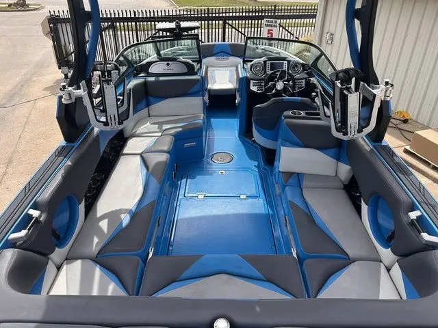 Slide: The Image of Interior of a 2018 Supra SL boat with blue and gray seating. - 14