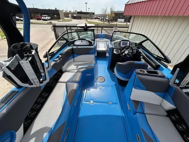Slide: The Image of Interior of a blue 2018 Supra SL boat with modern seating. - 15