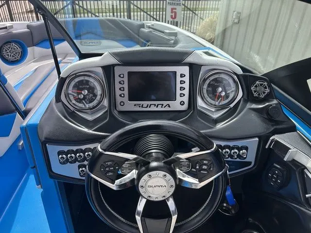 Slide: The Image of Dashboard of a 2018 Supra SL boat with modern gauges. - 17