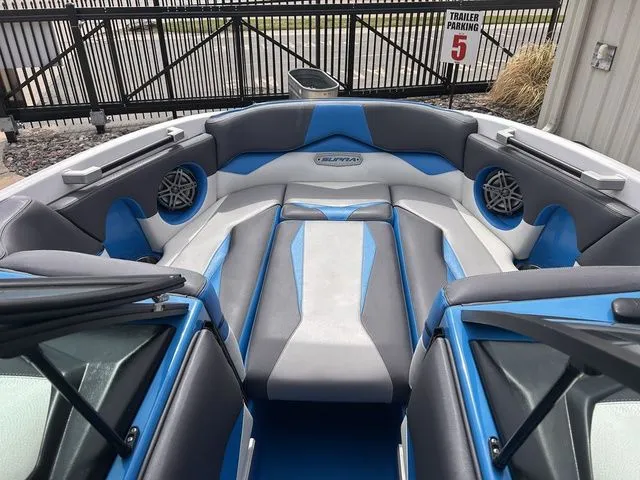 Slide: The Image of Interior of a 2018 Supra SL boat with blue and gray seating. - 21