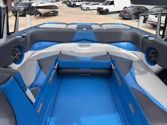 Slide: The Image of Interior of a blue 2018 Supra SL boat on a parking lot. - 24