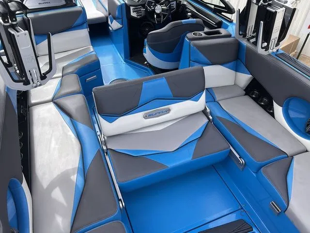 Slide: The Image of Interior of a 2018 Supra SL boat with blue and gray seating. - 29