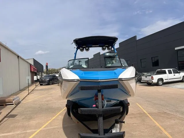 Slide: The Image of 2018 Supra SL boat on trailer in urban setting. - 3