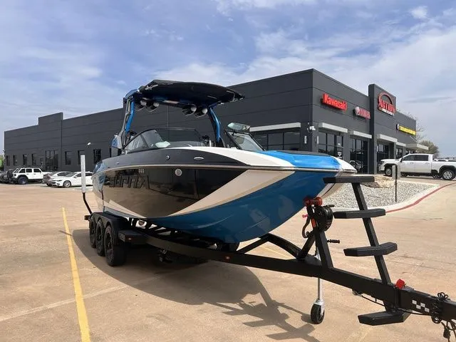 Slide: The Image of 2018 Supra SL boat on trailer outside a dealership. - 4