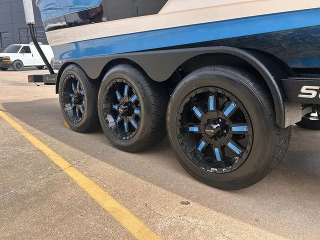 Slide: The Image of 2018 Supra SL boat trailer with stylish black and blue rims. - 6