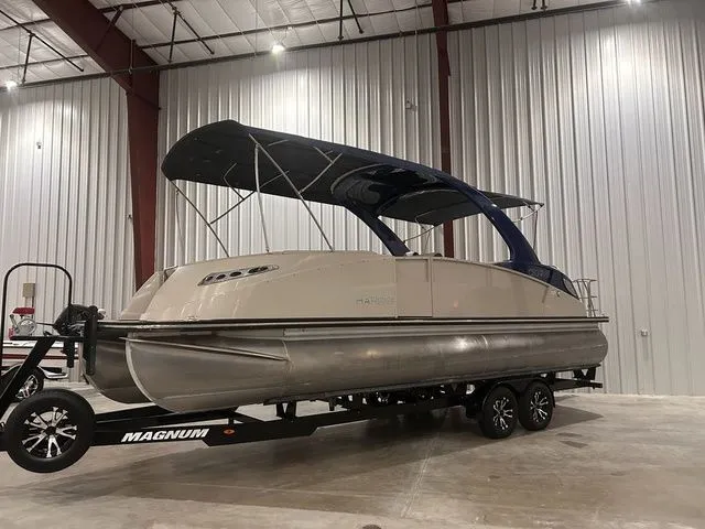 Slide: The Image of 2017 Harris Crowne Series SL 250 pontoon boat in warehouse. - 11