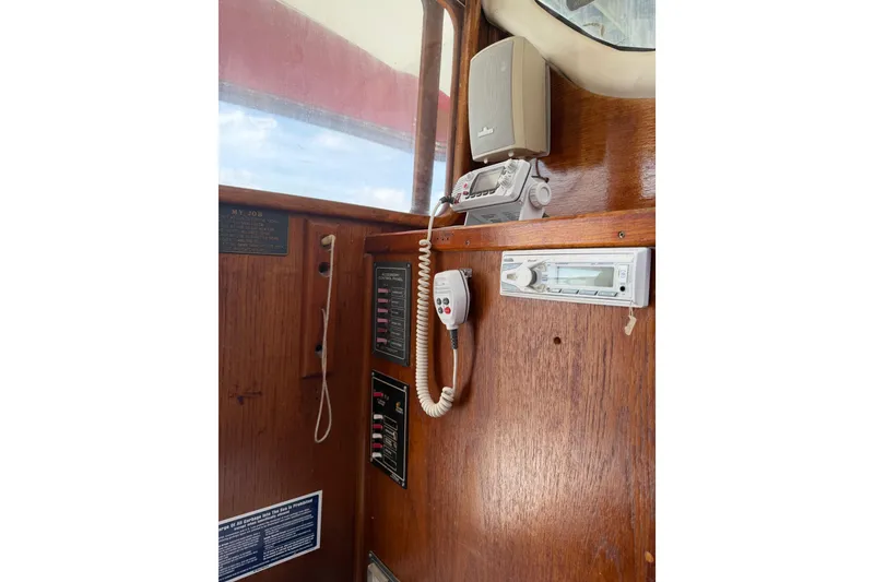 Slide: The Image of Interior of a 1989 Gemini 3000 boat with communication equipment and wooden paneling. - 11
