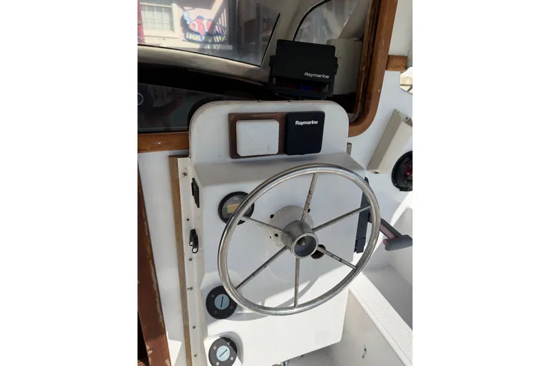 Slide: The Image of Helm of 1989 Gemini 3000 boat with Raymarine navigation equipment. - 14