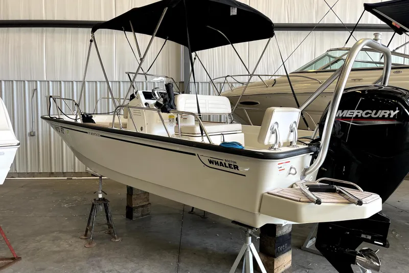 The Image of 2020 Boston Whaler 170 Montauk boat with Mercury engine in a storage facility. - 0