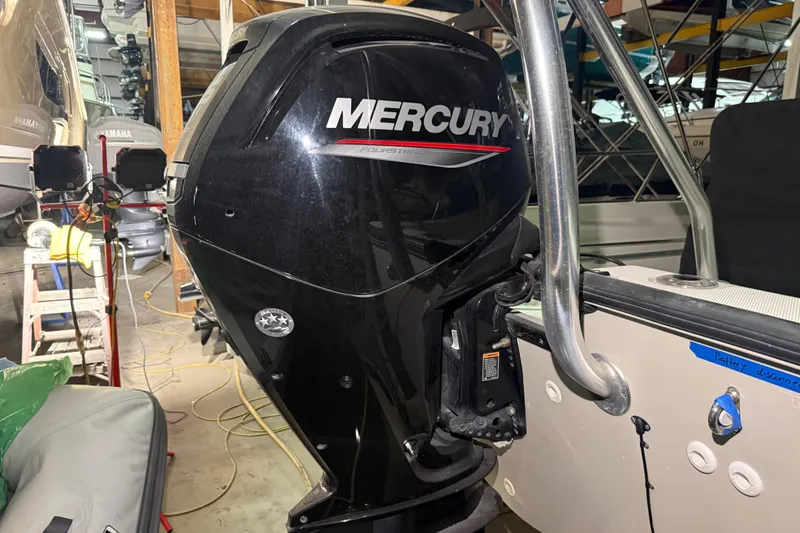 Slide: The Image of 2020 Boston Whaler 170 Montauk with Mercury outboard engine in a storage facility. - 11