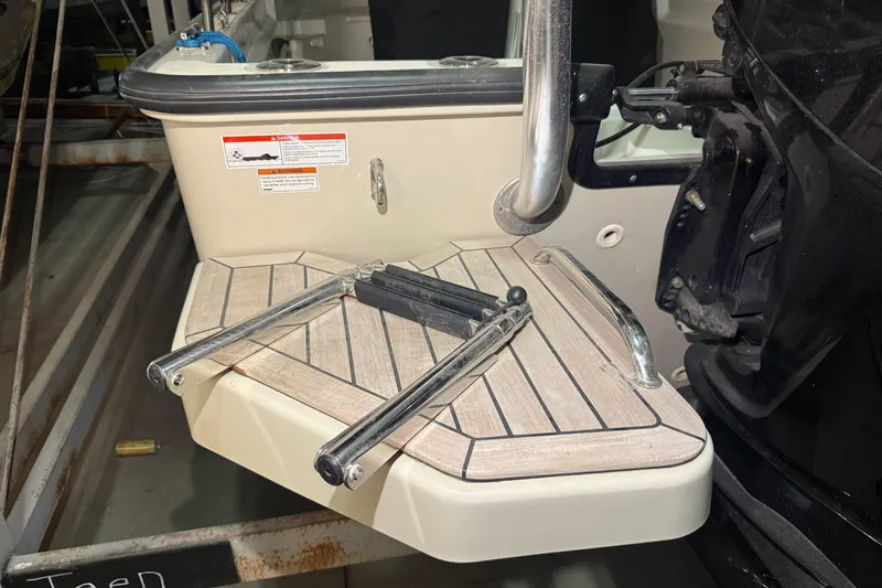 Slide: The Image of 2020 Boston Whaler 170 Montauk swim platform with foldable ladder and safety handle. - 12