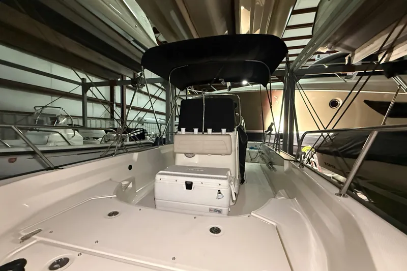 Slide: The Image of 2020 Boston Whaler 170 Montauk boat in storage, featuring spacious deck and seating. - 16
