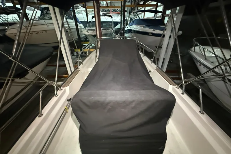 Slide: The Image of 2020 Boston Whaler 170 Montauk boat covered and docked in a marina. - 17