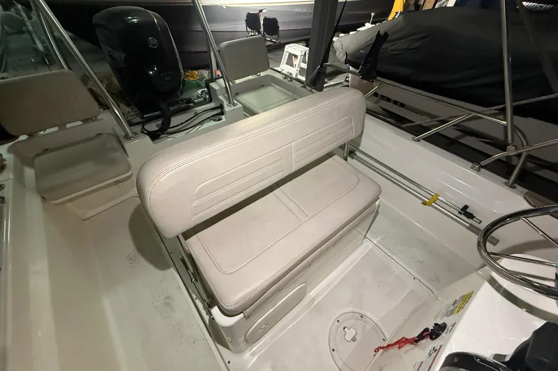 Slide: The Image of 2020 Boston Whaler 170 Montauk boat interior with seating and steering wheel. - 23