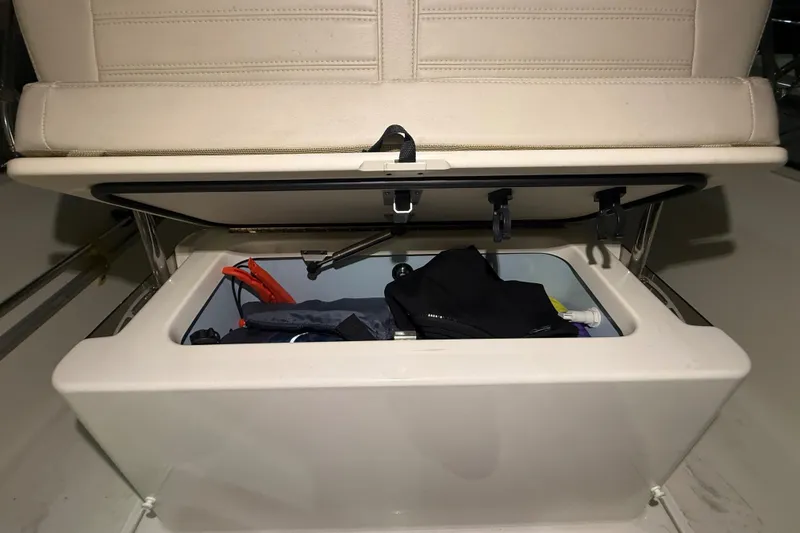 Slide: The Image of Storage compartment in a 2020 Boston Whaler 170 Montauk boat, containing various items. - 24