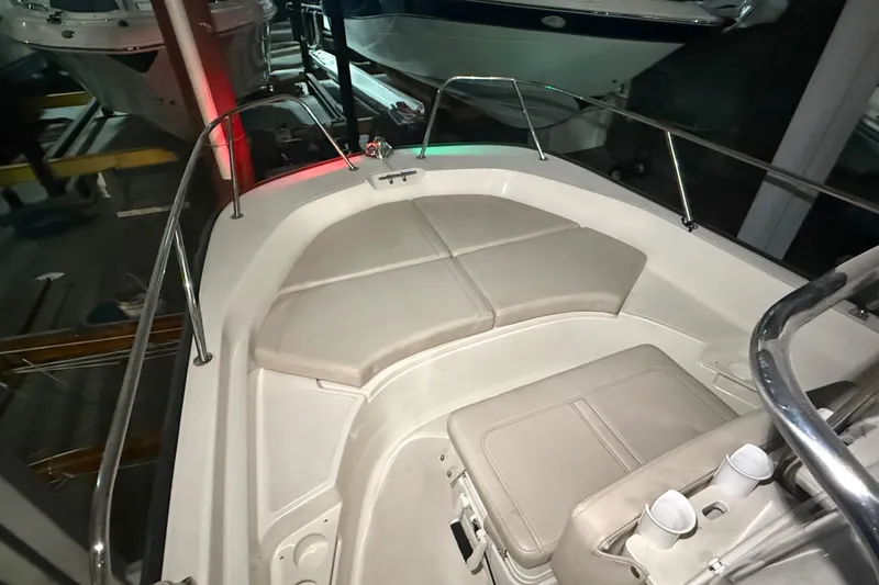 Slide: The Image of 2020 Boston Whaler 170 Montauk boat interior with cushioned seating and railing. - 25