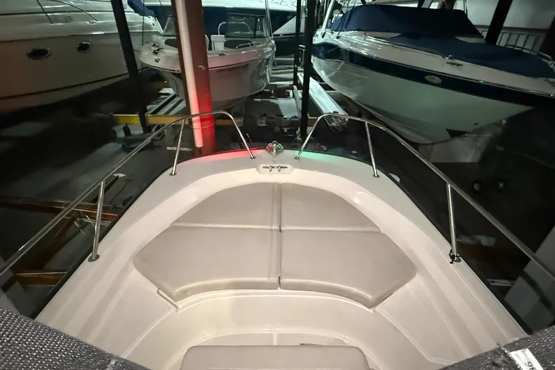 Slide: The Image of 2020 Boston Whaler 170 Montauk boat interior in storage, featuring cushioned seating. - 26