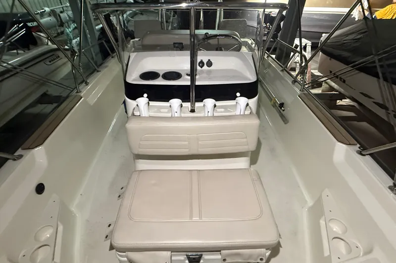 Slide: The Image of Interior view of a 2020 Boston Whaler 170 Montauk boat, featuring seating and console. - 27