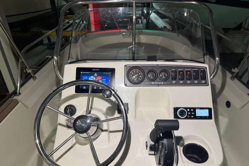 Slide: The Image of 2020 Boston Whaler 170 Montauk boat dashboard with steering wheel and control panel. - 29