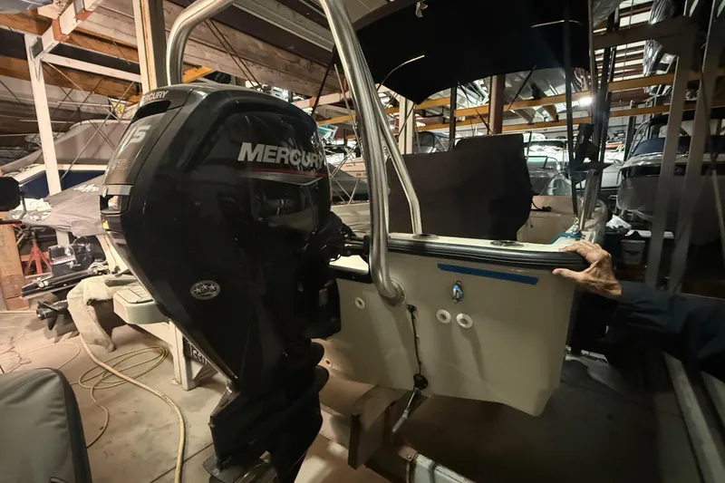 Slide: The Image of 2020 Boston Whaler 170 Montauk with Mercury outboard engine in a storage facility. - 6