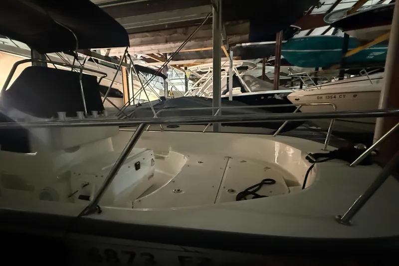 Slide: The Image of 2020 Boston Whaler 170 Montauk boat stored indoors, surrounded by other vessels. - 8