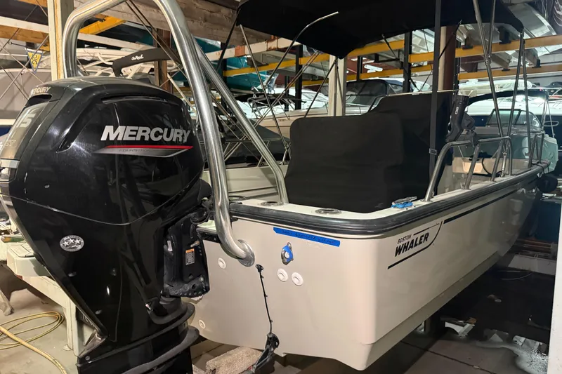 Slide: The Image of 2020 Boston Whaler 170 Montauk with Mercury outboard engine in storage. - 9