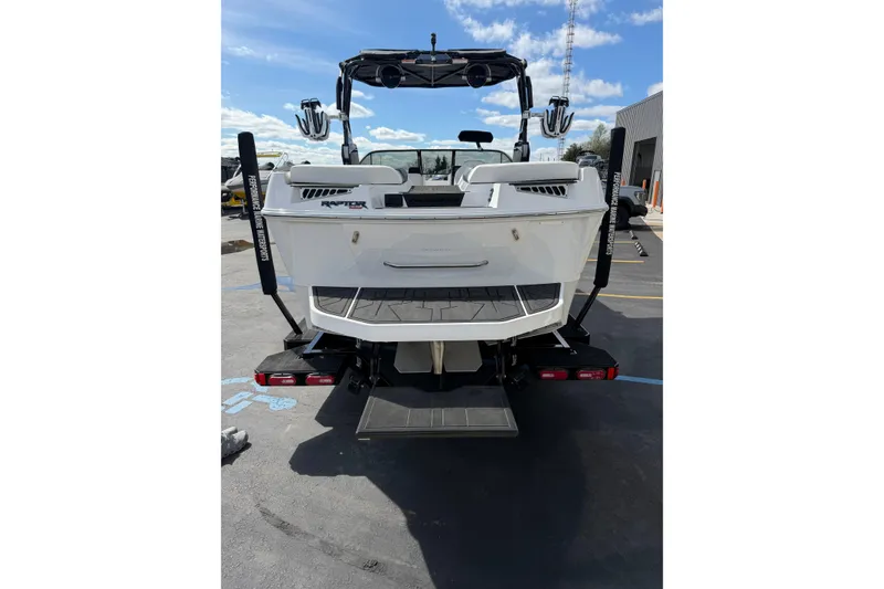 Slide: The Image of 2025 Moomba Makai boat rear view with Raptor engine, parked outdoors. - 10